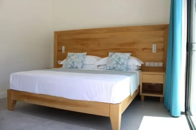 Comfortable beachfront bedroom at Lyla Beach Villa with modern decor and relaxing ambiance.