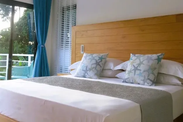 Lyla Beach Villa luxury bedroom with ocean views, modern decor, and cozy bedding, perfect for a relaxing beach getaway in Bali. Experience comfort and elegance at Lyla Beach Villa.