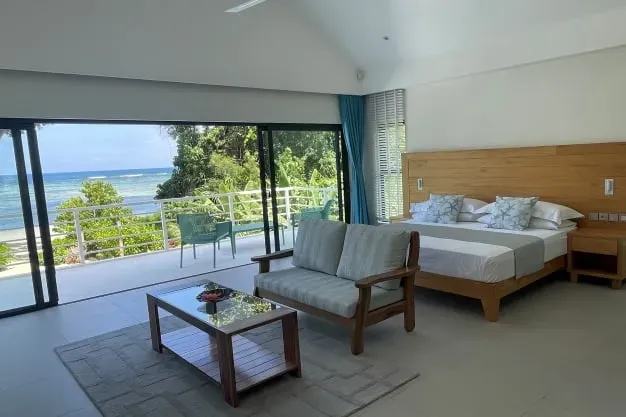 Luxurious beachfront main bedroom at Lyla Beach Villa with stunning ocean views and modern decor. Perfect for a relaxing getaway in a tropical paradise.
